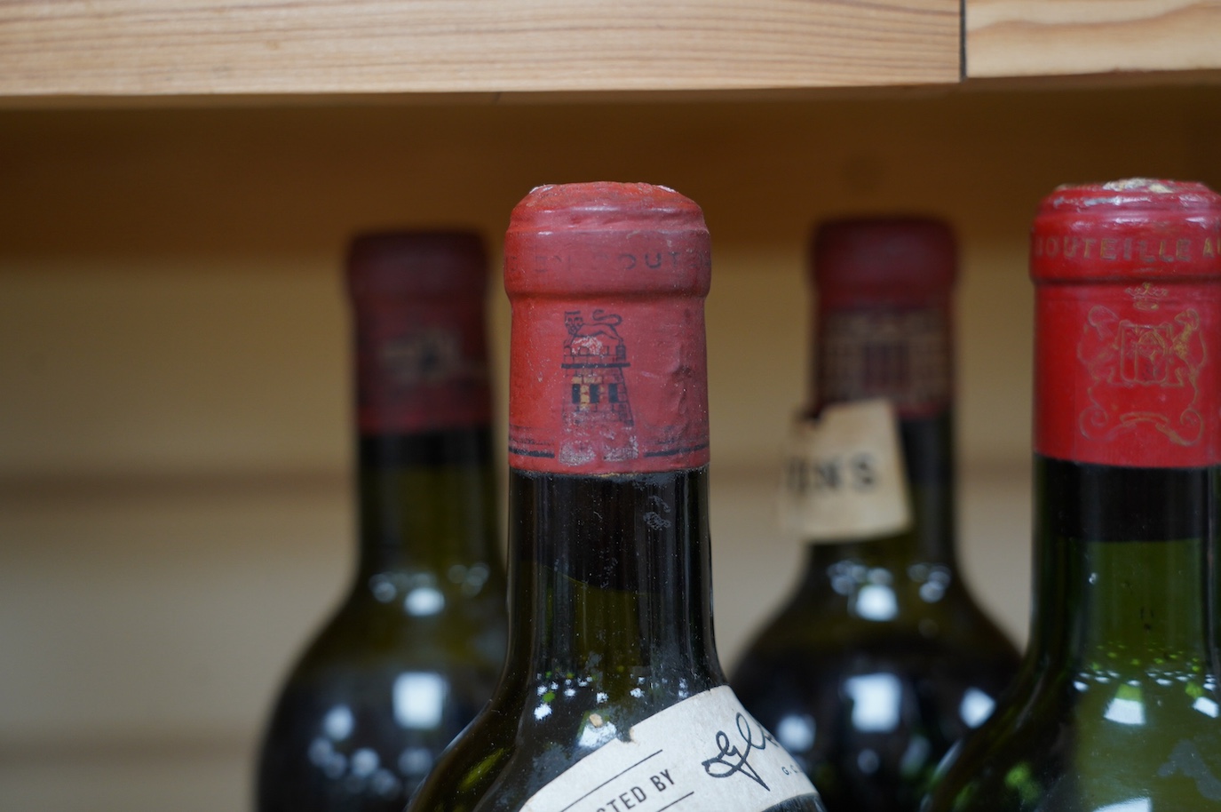 Four bottles of red wine; a Chateau Latour 1953, a Chateau Margaux 1953, a Chateau Mouton Rothschild, 1962, and a Chateau Rothschild 1952. Condition - fair to good, some foxing and peeling etc to labels
